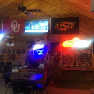 the inside of a sports bar with neon signs
