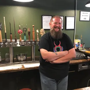 a man standing in front of a bar