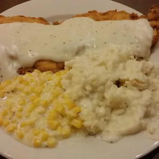 Chicken fried chicken with mashed potatoes and creamed corn.