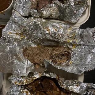 Top to bottom of half sandwich order to go: Smoked Beef Brisket, Smoked Pulled Pork, &amp; BBQ Chicken