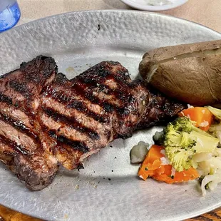 Aged Certified Angus Beef Rib Eye Steak with Baked Potato and Steamed Veg, Salad Bar