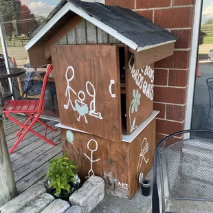  dog house with stickers on it