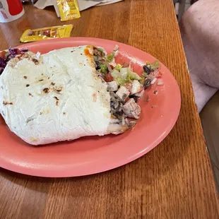 Half of a veggie especial burrito, added vegan chicken.