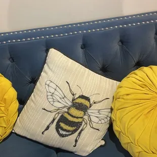 three pillows on a blue couch
