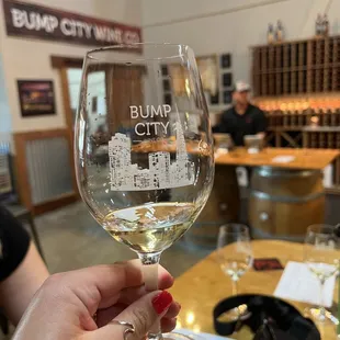 a hand holding a wine glass