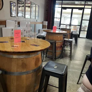a wooden barrel table and stools