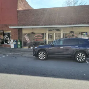 a car parked in front of a restaurant