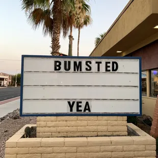 a sign in front of a building