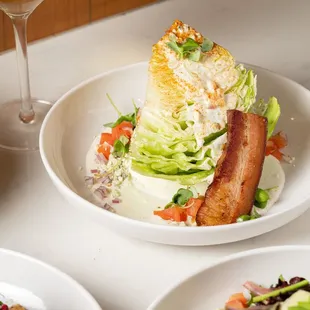 The Wedge (GF)
Iceberg Wedge Salad, Red Onion, Tomato, Baker&apos;s Bacon, Crumbled Blue Cheese, Blue Cheese Dressing.