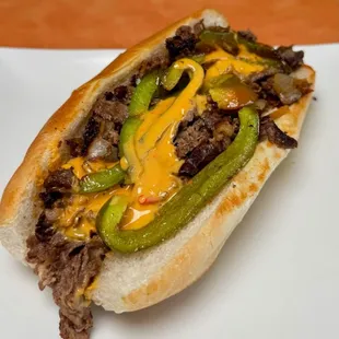Philly
Shaved Ribeye, Nacho Cheese, Peppers, Sauteed Mushrooms, Sauteed Onions, and Mayo. Served on a Hoagie Bun