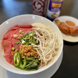 Always order your noodles uncooked and your thinly sliced beef raw and reheat the broth to boiling and put over the arranged bowl.