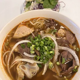 a bowl of soup and a plate of salad