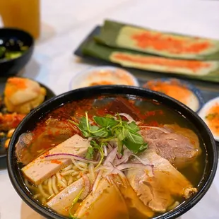 a bowl of soup with meat and vegetables