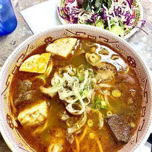 a bowl of soup and a plate of salad