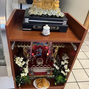 a buddha statue on a shelf