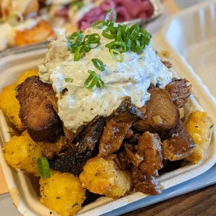 Fully loaded tater tots with crab rangoon and pork belly