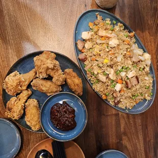 two plates of fried chicken and rice