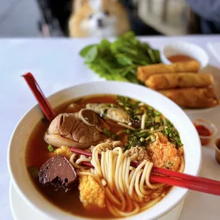 #6 Canh Bún: Viet crab paste soup w/ thick rice noodles, crab paste, tofu, pork blood, tomato ($16.95) ***add giò heo: pork hock (+$3)