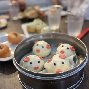 a pan of buns with pig faces on them