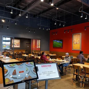 people sitting at tables in a restaurant