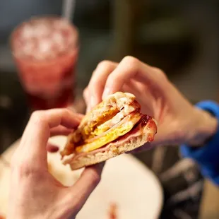 Our English Muffin Breakfast Sandwich comes with shaved ham, two eggs, cheddar cheese, &amp; raspberry jam on an english muffin.