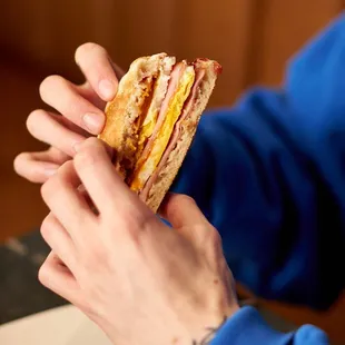 Our English Muffin Breakfast Sandwich comes with shaved ham, two eggs, cheddar cheese, &amp; raspberry jam on an english muffin.