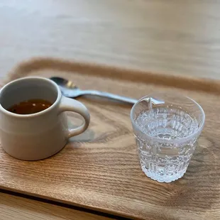 Double shot of Onyx's Monarch blend espresso. Served with a side of seltzer water and mixing spoon. Kinto aroma cup and tray is used here.