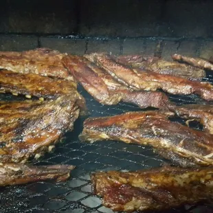ribs being cooked on a grill
