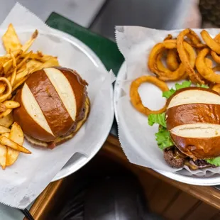 two plates of burgers and french fries