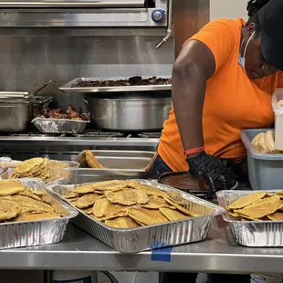 a woman preparing food in a kitchen