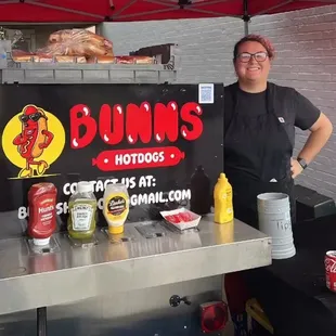 Front of hot dog cart with owner