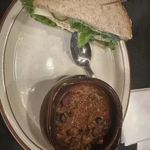 Bowl of Chili and half a club sandwich