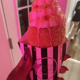 a hand holding a cupcake