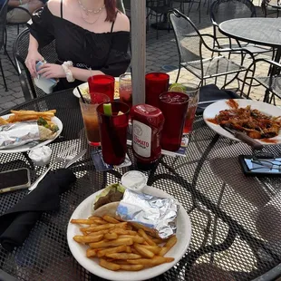 a woman sitting at a table with food