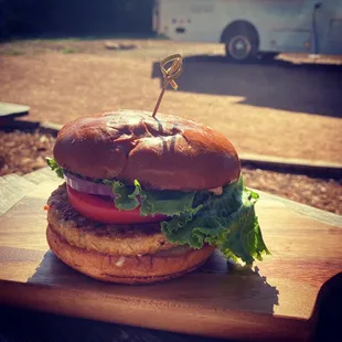 a hamburger with lettuce and tomatoes