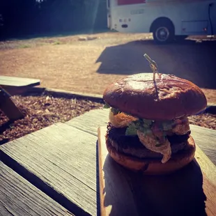 a hamburger on a picnic table