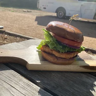 a burger on a wooden board