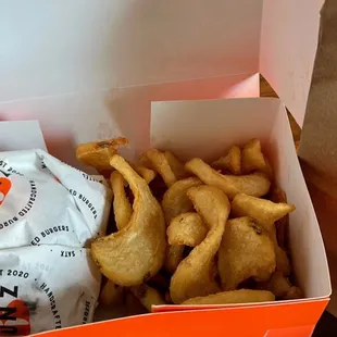 a box of onion rings and a bag of chips