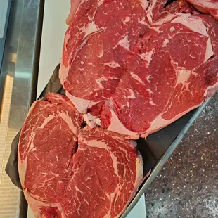 a person holding raw meat