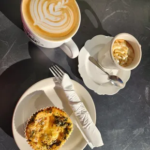 Large cafe latte, con panna, and a crustless quiche.