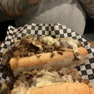 a man taking a picture of a sandwich