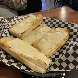 two pieces of cheese bread in a basket