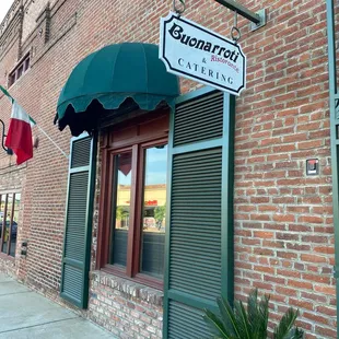a brick building with a green awning