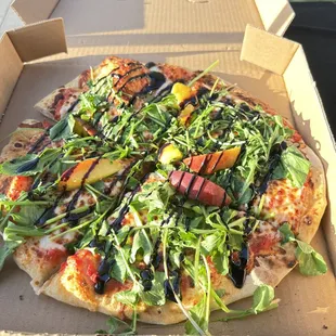 Peach arugula and balsamic pizza