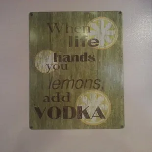 a sign on a wall that says when the hands you lemons add vodka