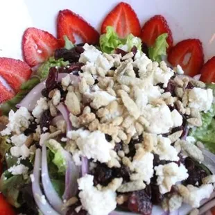 a salad with strawberries and feta cheese