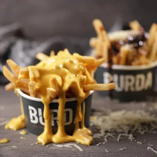 a bowl of fries and a cup of sauce