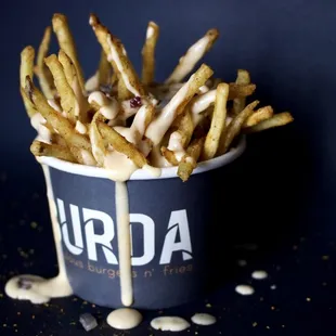 a cup of fries with sauce