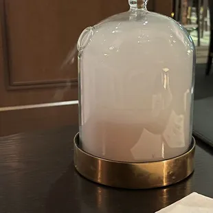 a glass clochet on a table