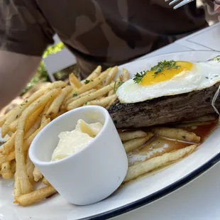 Steak frites served with fries and maitre d&apos; hotel butter